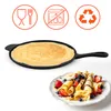 A cast iron pan with a crepe and a plate of crepes with berries. Produktbild-Vorschau