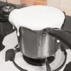 A pot of milk is boiling over on a stovetop. Náhľad obrázku produktu