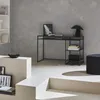A modern living room or office space with a black metal desk and shelves. Anteprima dell’immagine prodotto