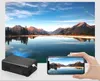 A mini projector is shown next to a smartphone displaying the same image as the projector. Náhľad obrázku produktu