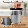 A person is holding a black handle above a stainless steel knock box. Produktbild-Vorschau