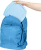A hand is placing a light blue board game into a blue backpack. Produktbild-Vorschau