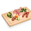 A selection of cured meats, sausages, cherry tomatoes, cucumber slices, and parsley arranged on a wooden cutting board. Anteprima dell’immagine prodotto