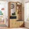 A hallway or entryway with a wooden furniture set including a mirror, hooks, and storage. Produktbild-Vorschau