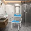 A modern bathroom with a shower chair in the foreground, a sink and vanity to the left, and a shower stall to the right. Náhled obrázku produktu