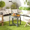 A small round table with drinks and fruit on a patio with artificial grass. Produktbild-Vorschau