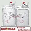 Two duvet covers and pillowcases with a romantic design, featuring hands connected by a red thread and the words 'Mr.' and 'Mrs.' Produktbild-Vorschau