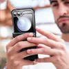 A person is holding a smartphone with a protective case. Produktbild-Vorschau