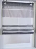 A close-up view of a Roman blind with horizontal stripes in various shades of gray and black, hanging in a window frame. Produktbild-Vorschau