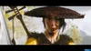 A close-up portrait of a woman wearing a traditional hat and yellow clothing, holding a musical instrument. Produktbild-Vorschau