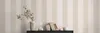 A shelf with decorative items against a striped wallpaper. Produktbild-Vorschau