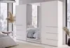A bedroom with a large white wardrobe with mirrored doors, reflecting a bed and a window view. Produktbild-Vorschau