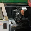 A man is working on a machine in a workshop. Anteprima dell’immagine prodotto
