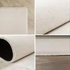 A collage of four close-up images showing different angles and textures of a cream-colored rug. Produktbild-Vorschau