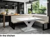 A modern kitchen with a dining nook featuring a banquette and a table. Produktbild-Vorschau