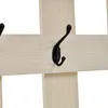 Close-up of a wooden coat rack with black metal hooks. Náhľad obrázku produktu