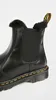 Close-up of a black Dr. Martens Chelsea boot with faux fur lining. Produktbild-Vorschau