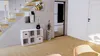 A modern living room with a staircase, a white cube shelf, and a door. Náhled obrázku produktu