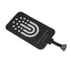A black wireless charging receiver patch with white accents and text, lying flat on a white background. Voir les images du produit