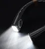 A close-up shot of a black neck fan with its lights on, casting a bright beam. Produktbild-Vorschau