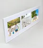 A white multi-photo frame with three beach-themed pictures displayed, set against a light gray background. Produktbild-Vorschau