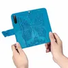Hands holding a blue phone case with a butterfly embossed design. Produktbild-Vorschau