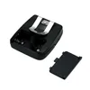 The image shows the back of a black electronic device, likely a communication device, with its battery compartment open and the battery cover removed, set against a white background. Náhled obrázku produktu