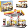 A collage of images showing a Shell gas station building toy set, including the box and assembled models. Anteprima dell’immagine prodotto