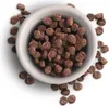 A bowl of brown kibble with some kibble scattered around it. Náhľad obrázku produktu