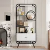 A modern black and white bookshelf with decorative items and a fireplace in the background. Produktbild-Vorschau