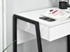 A close-up view of a white desk with a black metal frame, showing a drawer, a magazine, and a smartphone. Anteprima dell’immagine prodotto