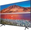 A television displaying a landscape scene with a mountain, a pink lake, and flamingos. Produktbild-Vorschau
