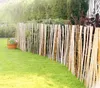 A garden scene with a wooden picket fence and a flower pot. Produktbild-Vorschau