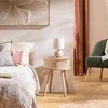 A bedroom scene with a bed, a bedside table with a lamp, and a chair. Voir les images du produit