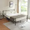 A modern bedroom scene with a metal bed frame, pillows, and a blanket. Voir les images du produit