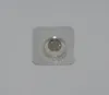 A single button cell battery in a clear plastic blister pack, lying on a light gray surface. Produktbild-Vorschau