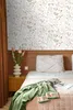 A bedroom scene with a bed, curtains, and a nightstand, featuring wallpaper. Podgląd zdjęcia produktu