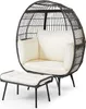 A dark gray rattan egg chair with white cushions and a matching ottoman, presented against a white background. Anteprima dell’immagine prodotto