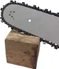 A chainsaw bar and chain resting on a wooden block. Produktbild-Vorschau
