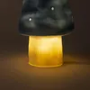 A close-up shot of a mushroom-shaped lamp, lit from within. Produktbild-Vorschau