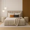 A bedroom setting with a bed, pillows, a blanket, and decorative elements. Podgląd zdjęcia produktu