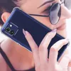 A woman is holding a smartphone with a transparent case to her ear, as if making a call. Produktbild-Vorschau
