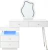 A white vanity table with a unique shaped mirror with LED lights and a matching white nightstand with blue LED lights. Voir les images du produit