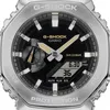 Close-up of a silver G-Shock watch with a black face and gold accents. Voir les images du produit