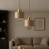 Two pendant lights hang above a sofa in a living room. Produktbild-Vorschau