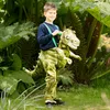 Junge im Garten mit dem Licht-&-Sound-T-Rex Kostüm, als würde er auf dem Dino reiten. Produktbild-Vorschau