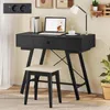 A black vanity desk with a laptop, lamp, and stool in a room. Podgląd zdjęcia produktu