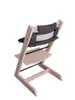 A high chair with cushions, shown from the back. Voir les images du produit