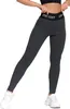 A person wearing dark gray leggings and white sneakers, standing against a white background. Produktbild-Vorschau