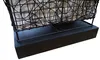 A close-up view of the base of a black wire basket lamp with a beige fabric lining, resting on a black rectangular base. Náhled obrázku produktu